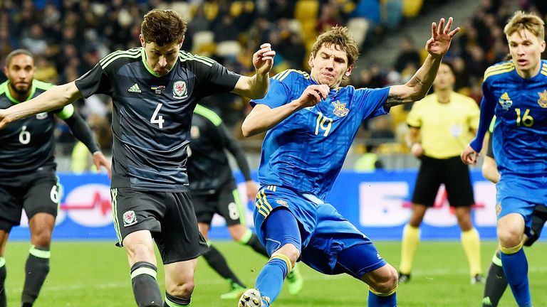 Ben Davies of Wales is challenged by Denys Garmash of Ukraine