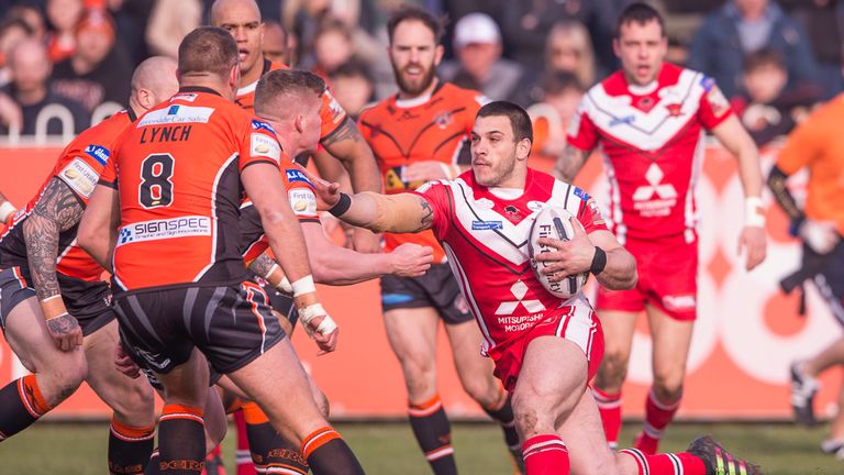 Castleford Tigers v Salford Red Devils - The Mend-A-Hose Jungle, Castleford, England - Salford's Justin Carney fends off ex-team mate Oliver Holmes.