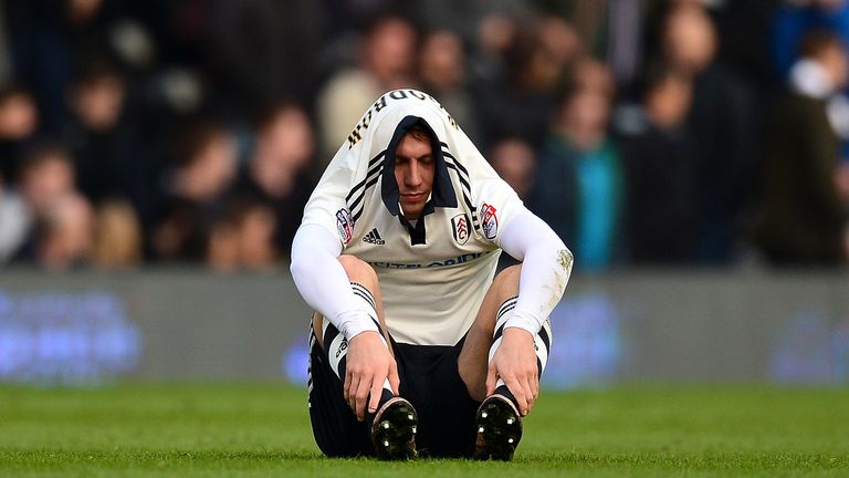 Cauley Woodrow of Fulham sits dejected after the final whistle