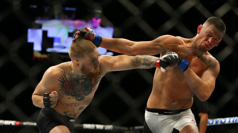 Conor McGregor punches Nate Diaz during UFC 196 at the MGM Grand Garden Arena on March 5, 2016 in Las Vegas, Nevada. (Photo by 