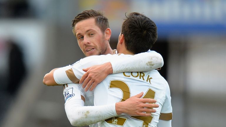 Gylfi Sigurdsson (L) and Jack Cork (R) of Swansea City celebrate their 1-0 win in the Barclays Premier League match between Swa