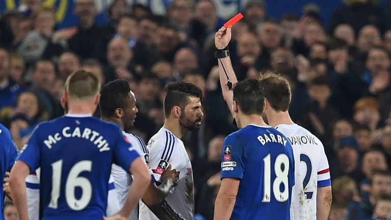 Chelsea's Brazilian-born Spanish striker Diego Costa (C) is shown a red card by referee Michael Oliver during the English 