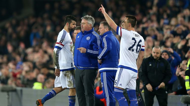 Diego Costa (1st L) of Chelsea walks off the pitch past Guus Hiddink (2nd L) after the red card 