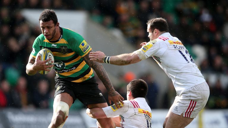 Courtney Lawes of Northampton is tackled by Ben Botica and Jamie Roberts (R) during the Aviva Premiership match between Northampton Saints and Harlequins