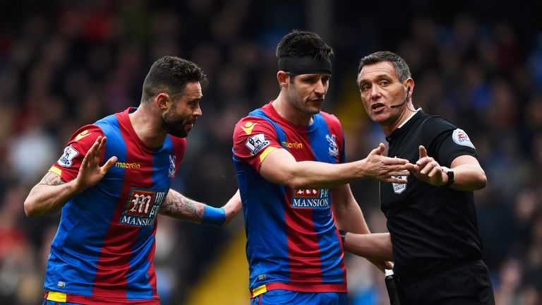 Damien Delaney and Scott Dann of Crystal Palace appeal to referee Andre Marriner as he awards Liverpool a penalty