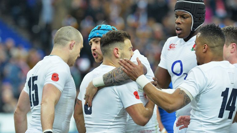 Danny Care of England celebrates his try with team mates against France