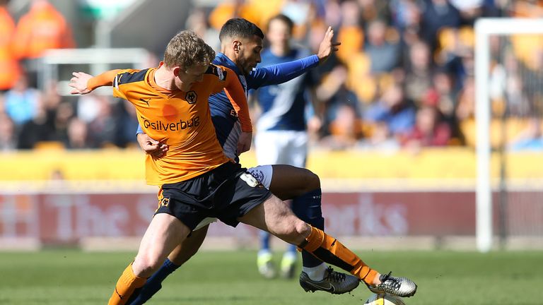 Birmingham's David Davis and Wolves' George Saville (left) battle for the ball during the Sky Bet Championship match at Molineux, Wolverhampton.
