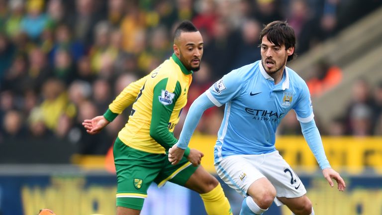 David Silva of Manchester City and Nathan Redmond of Norwich City compete for the ball