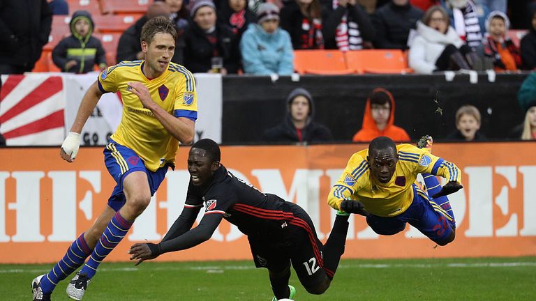 DC United's Patrick Nyarko (centre) gets tangled with Colorado Rapids defender Michael Azira (right)