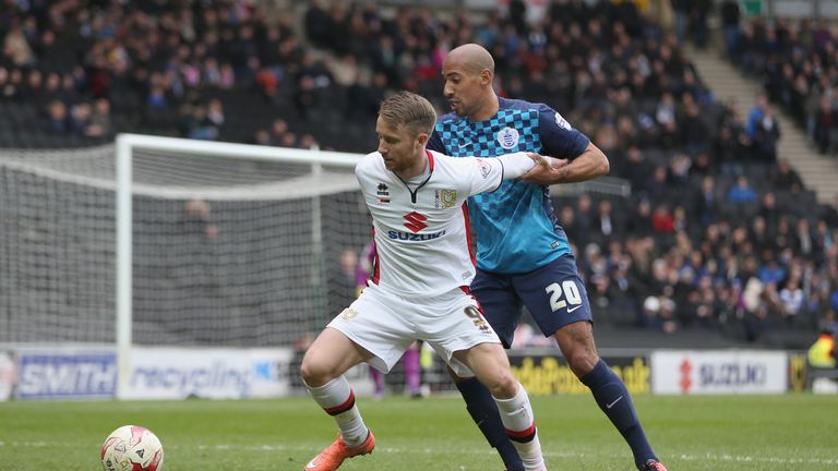 Dean Bowditch of MK Dons holds off QPR's Karl Henry