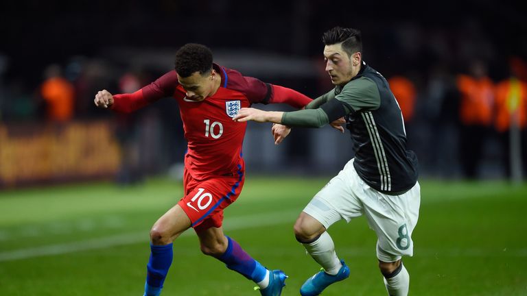 BERLIN, GERMANY - MARCH 26:  Dele Alli of England and Mesut Oezil of Germany compete for the ball during the International Friendly match between Germany a