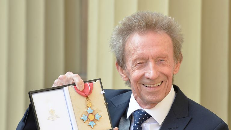 Denis Law poses with his  Commander of the Order of the British Empire 