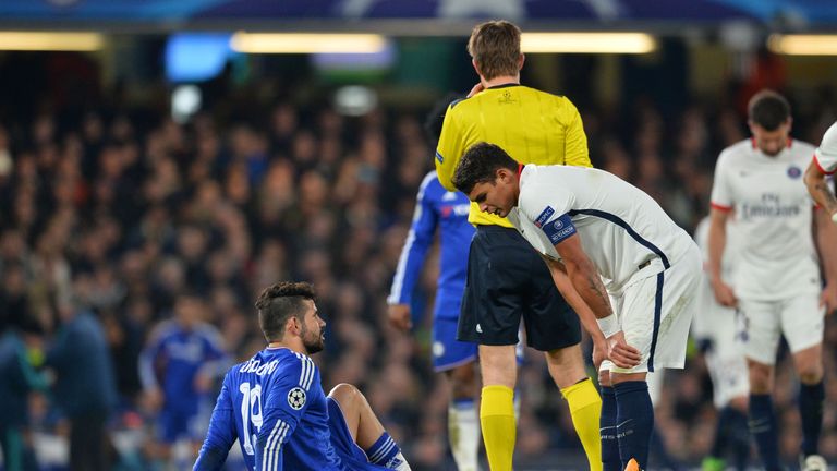 Chelsea striker Diego Costa (L) sits injured on the pitch