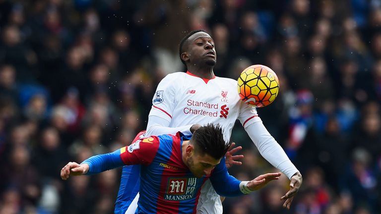 Divock Origi of Liverpool jumps with Scott Dann and Joel Ward of Crystal Palace 