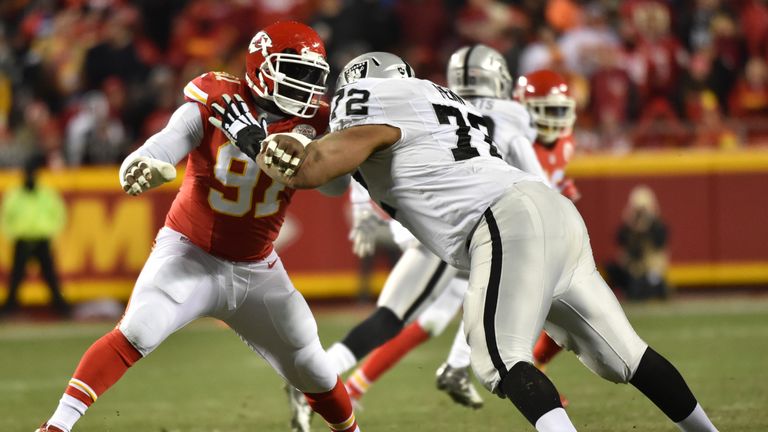 Tamba Hali #91 of the Kansas City Chiefs rushes the passer while being blocked by Donald Penn #72 of the Oakland Raiders at Ar