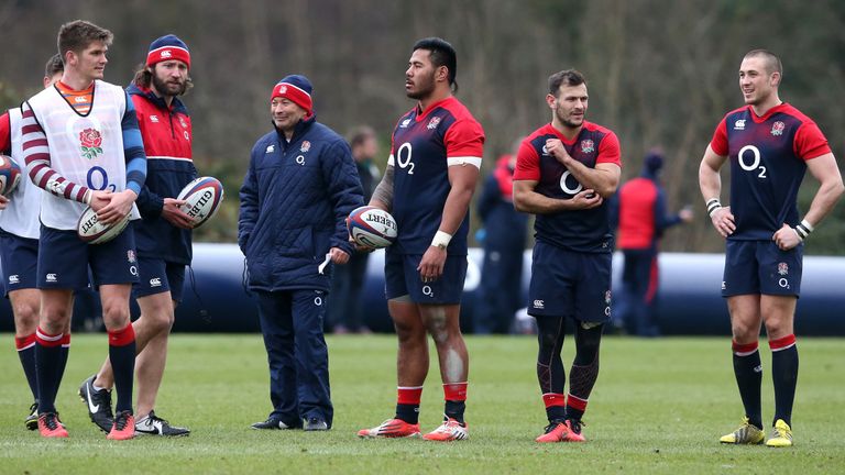 Eddie Jones (C) the England head coach looks on with Manu Tuilagi during the England training session held at Pennyhill Park on March 8 2016