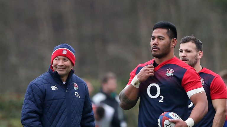 Manu Tuilagi holds onto the ball as Eddie Jones, the head coach, looks on