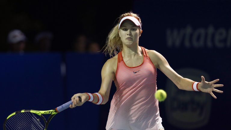 Eugenie Bouchard of Canada plays a return shot to Cagla Buyukakcay of Turkey during the quarter-finals of the Malaysian Open