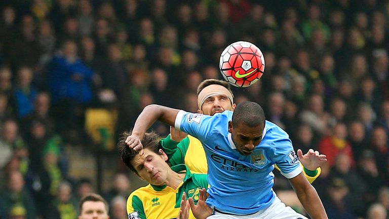 Fernandinho (R) of Manchester City competes for the ball against Timm Klose (L) and Gary O'Neil (C) of Norwich City  during the Barclays Premier League