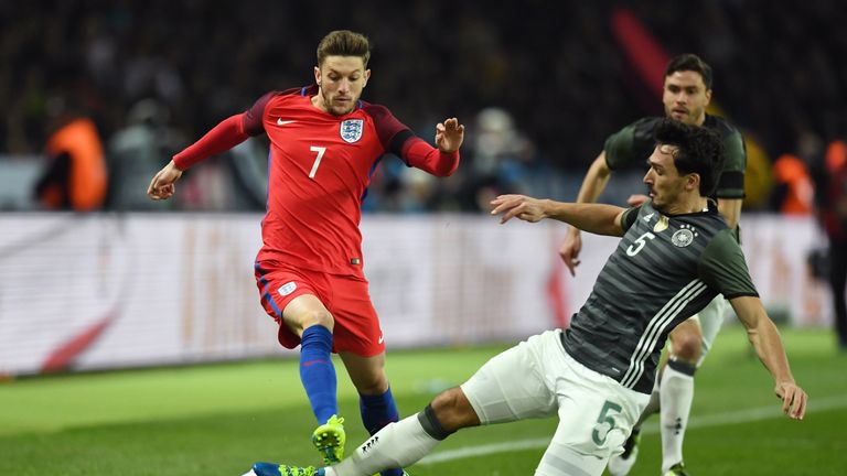 Adam Lallana of England is tackled by Mats Hummels of Germany during the International Friendly