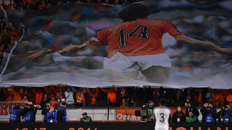 A large banner is displayed during a standing ovation  in honour of late Dutch football legend Johann Cruyff