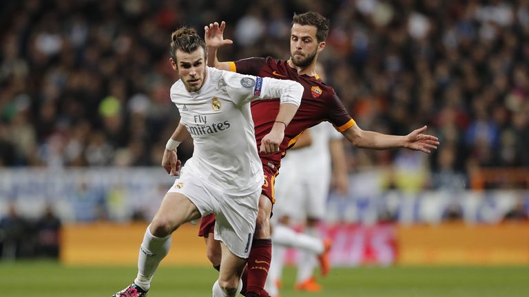 Gareth Bale is challenged by Miralem Pjanic during Champions League match between Real Madrid and AS Roma at the Santiago Bernabeu on March 8