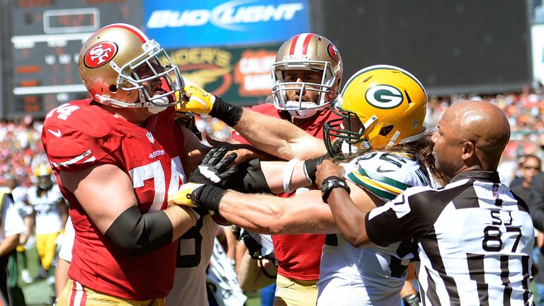 Clay Matthews #52 of the Green Bay Packers and Joe Staley #74 of the San Francisco 49ers gets into a fight after Matthew