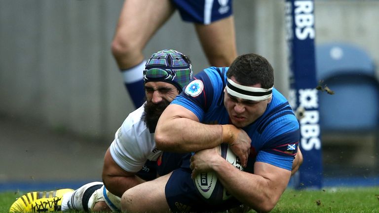 Guilhem Guirado of France scores the opening try despite a tackle from Josh Strauss of Scotland during the Six Nations