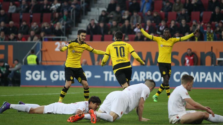 Henrikh Mkhitaryan (topC) of Borussia Dortmund celebrates his goal with Nuri Sahin (L) and Ramos Vasquez during the Bundesliga match at FC Augsburg