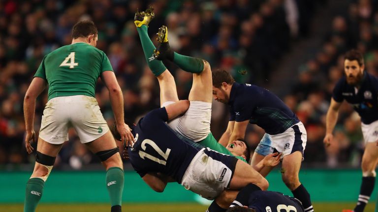 Ireland's Johnny Sexton is tackled by Alex Dunbar of Scotland during the Six Nations clash in Dublin