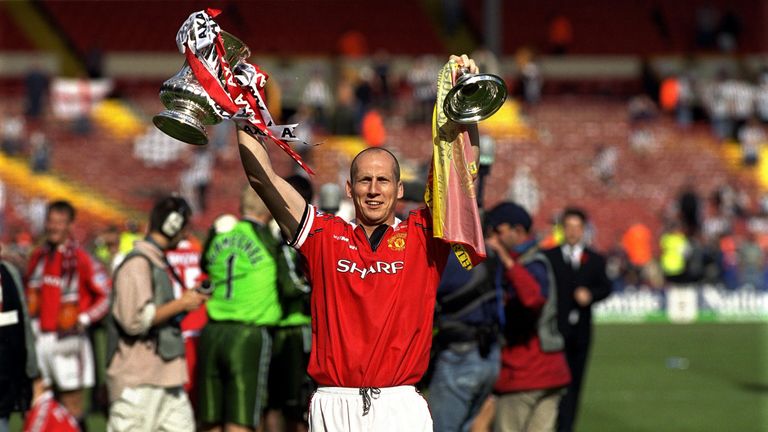 Jaap Stam lifts the FA Cup in 1999 on his way to a treble with Manchester United