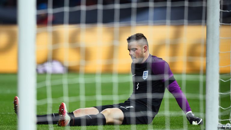 Butland lies on the pitch as he gets injured 