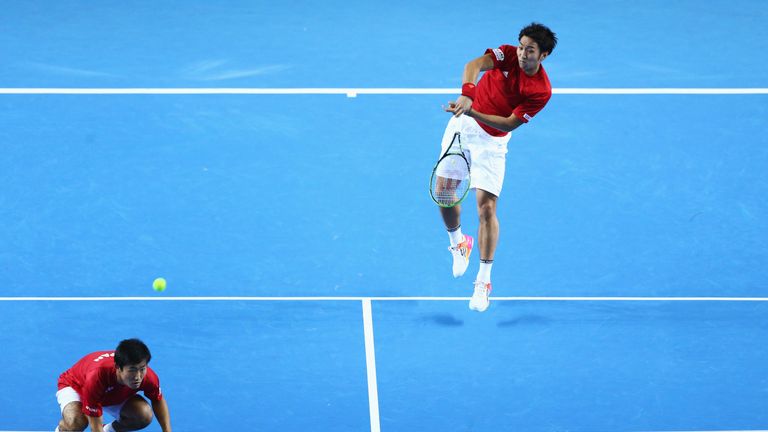 BIRMINGHAM, ENGLAND - MARCH 05: Yasutaka Uchiyama (R) of Japan plays a forehand in the double match against Andy Murray and Jamie Murray during day two of 