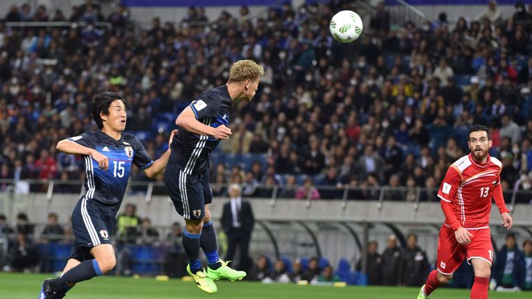 Keisuke Honda heads in a goal during his side's emphatic win. 