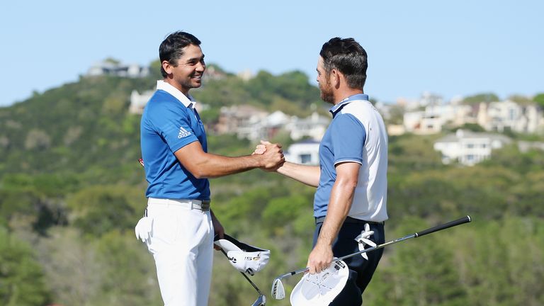 Jason Day of Australia (L) shakes hands with Louis Oosthuizen of South Africa on the 14th green 