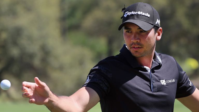 Jason Day of Australia reaches for a golf balll on the practice ground during the second round of the World Golf Championships-Dell