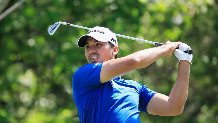 Jason Day plays his tee shot at the 18th hole against Rory McIlroy 