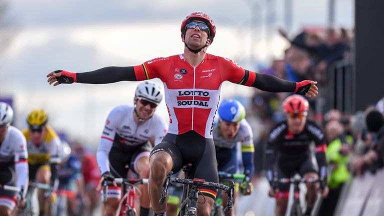 Belgian cyclist Jens Debusschere of Lotto Soudal celebrates as he crosses the finish line to win the 71st edition of the Dwars Door Vlaanderen race