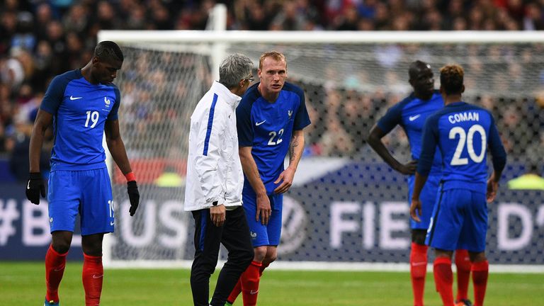 France's defender Jeremy Mathieu (C) leaves the pitch after getting injured during the international friendly football match between France and Russia
