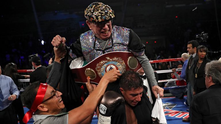 Vargas celebrates victory by carrying his godfather and cutman Rafael Garcia