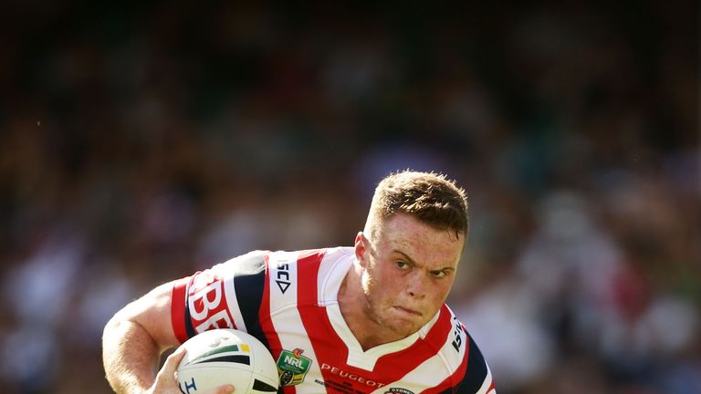Joe Burgess of the Roosters runs with the ball during their NRL clash with the Rabbitohs