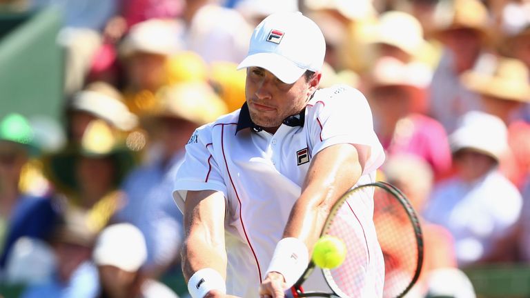 John Isner of the United States plays a backhand in his match against Sam Groth of Australia during the Davis Cup tie.