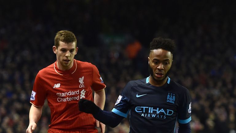 Jon Flanagan of Liverpool competes with Raheem Sterling of Manchester City