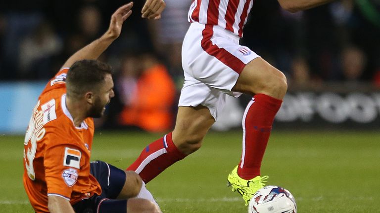 Stoke City's Steve Sidwell and Luton Town Josh McQuoid battle for the ball during the Capital One Cup, second round match at Kenilworth Road, Luton.