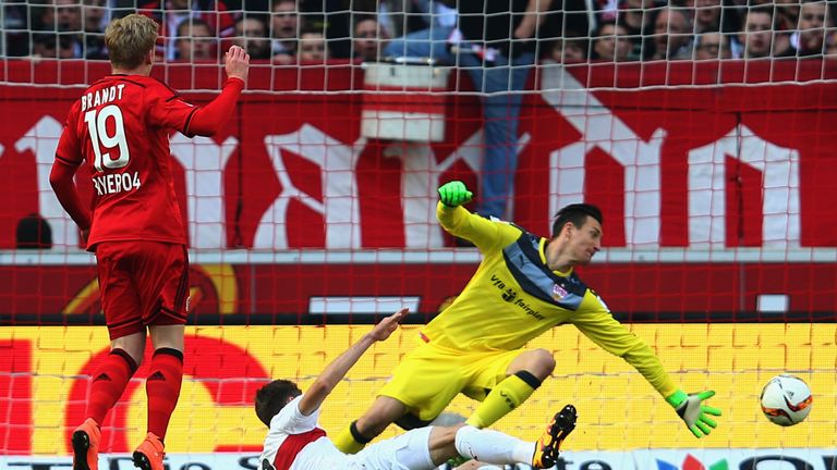 Julian Brandt of Leverkusen scores his team's first goal against Daniel Schwaab and goalkeeper Przemyslaw Tyton of Stuttgart