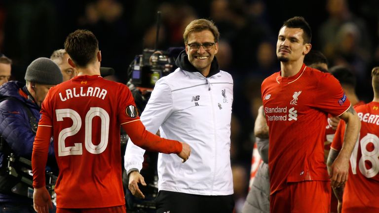 Jurgen Klopp (centre) celebrates with Adam Lallana (left) after the final whistle during the UEFA Europa League, Round of 16 clash v Manchester United