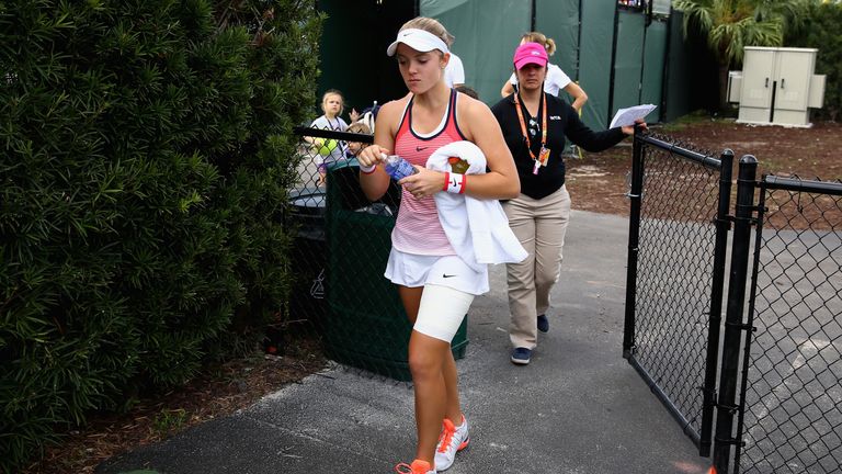 Katie Swan of Great Britain walks back onto court after a medical time out in her final qualifying round match for Miami Open