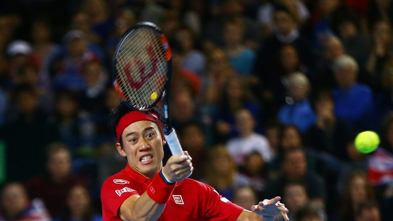 Kei Nishikori of Japan hits a forehand during the singles match against Andy Murray of Great Britain on day three of the Davis Cup tie