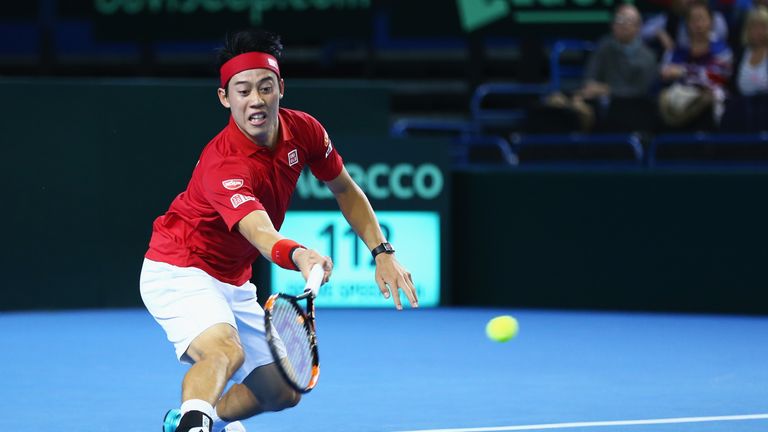 Kei Nishikori of Japan returns in his singles match against Daniel Evans of Great Britain during day one of the Davis Cup 