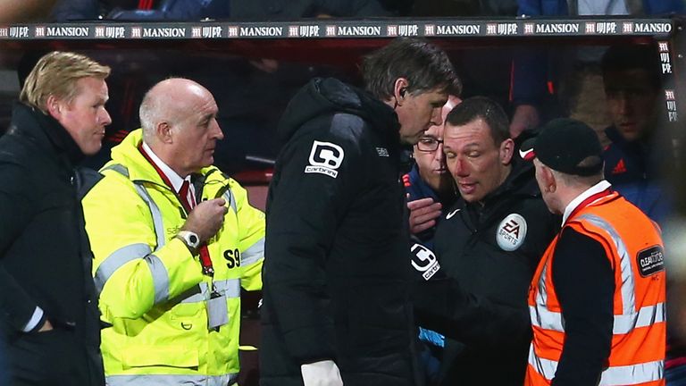 Blooded fourth official Kevin Friend receives treatment 